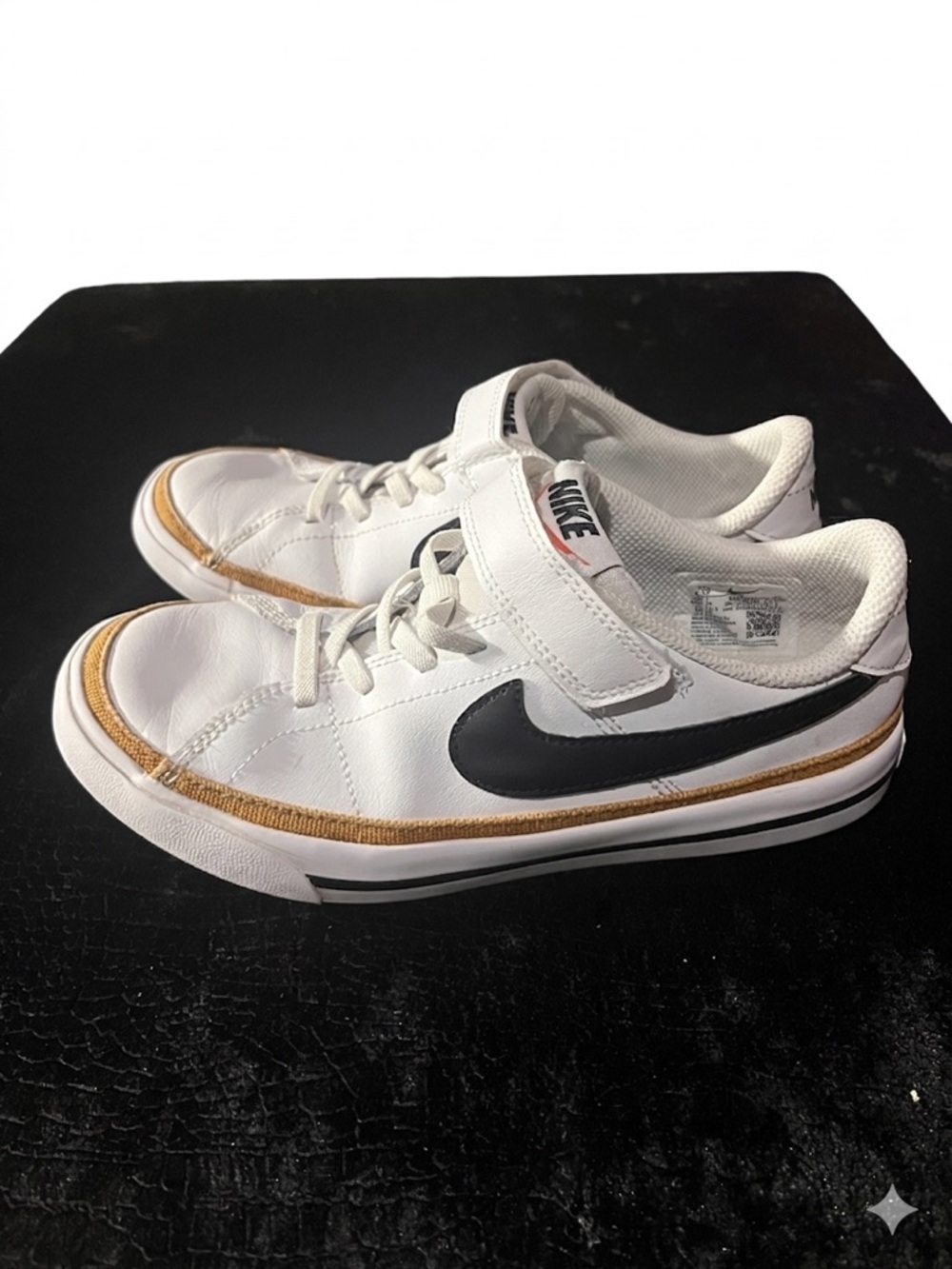 Nike Kids White Sneakers with Black Swoosh and Gold Accent